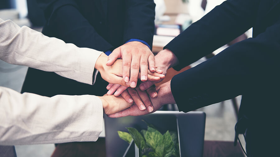 business partners with hands together